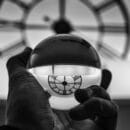 grayscale photography of person holding glass ball