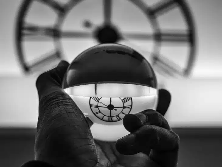 grayscale photography of person holding glass ball